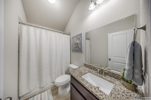 12322 Saddle Up Dr, San Antonio, TX 78254 - full bath featuring vaulted ceiling, vanity, toilet, shower / tub combo with curtain, and wood finished floors