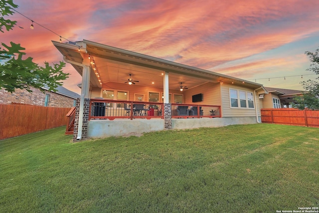12322 Saddle Up Dr, San Antonio, TX 78254 - back of property at dusk with a ceiling fan