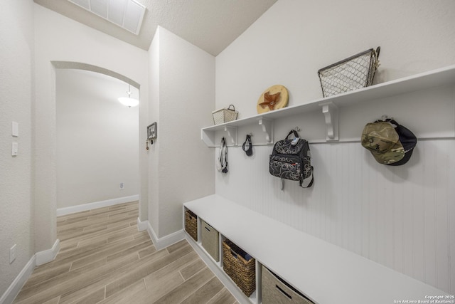12322 Saddle Up Dr, San Antonio, TX 78254 - mudroom with light wood-style floors, baseboards, and arched walkways