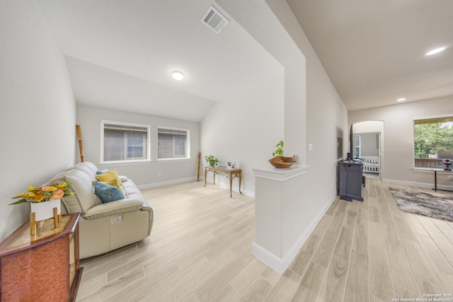 12322 Saddle Up Dr, San Antonio, TX 78254 - living area with arched walkways, light wood-style floors, baseboards, recessed lighting, and lofted ceiling