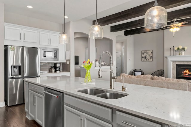 3130 Running Fawn, San Antonio, TX 78261 - kitchen with appliances with stainless steel finishes, a sink, open floor plan, dark wood finished floors, and light stone countertops