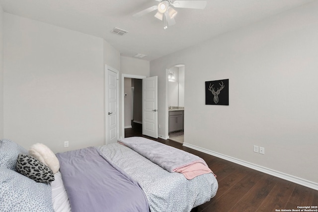 3130 Running Fawn, San Antonio, TX 78261 - bedroom featuring dark wood-style floors, arched walkways, baseboards, ceiling fan, and ensuite bathroom
