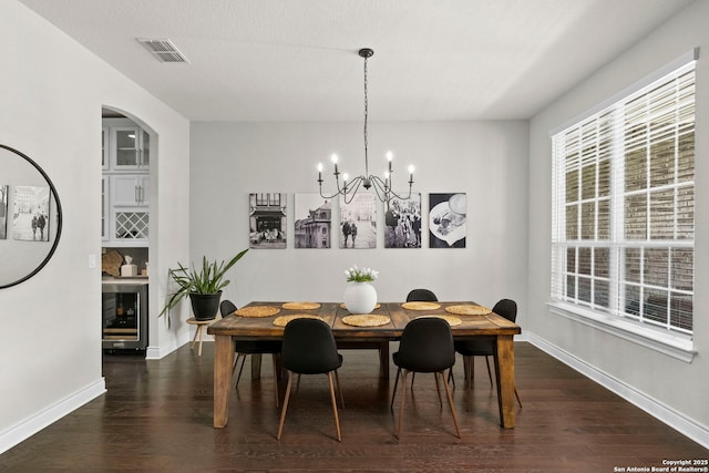 3130 Running Fawn, San Antonio, TX 78261 - dining room with beverage cooler, dark wood-type flooring, a chandelier, and plenty of natural light