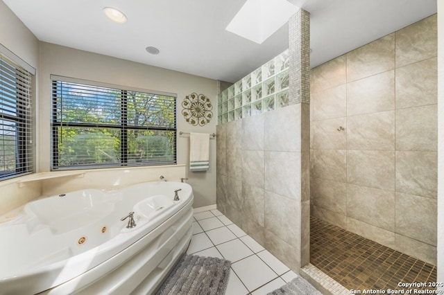 711 Cardinal Dr, Kerrville, TX 78028 - full bathroom with a tub with jets, tile patterned flooring, a skylight, a walk in shower, and recessed lighting