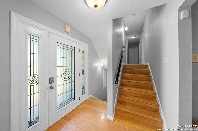 711 Cardinal Dr, Kerrville, TX 78028 - entrance foyer with light wood-style floors, stairs, baseboards, and lofted ceiling