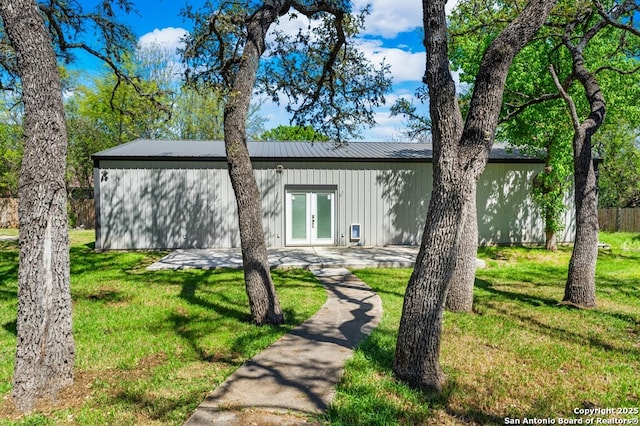 711 Cardinal Dr, Kerrville, TX 78028 - view of front of house featuring french doors, a front lawn, and metal roof