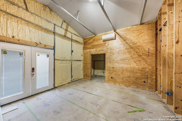 711 Cardinal Dr, Kerrville, TX 78028 - interior space featuring a wall mounted AC, lofted ceiling, and wood walls