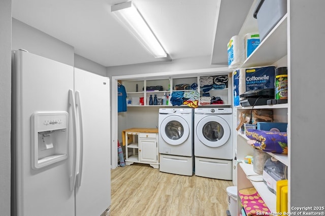 711 Cardinal Dr, Kerrville, TX 78028 - laundry room with washer and clothes dryer and light wood-style flooring