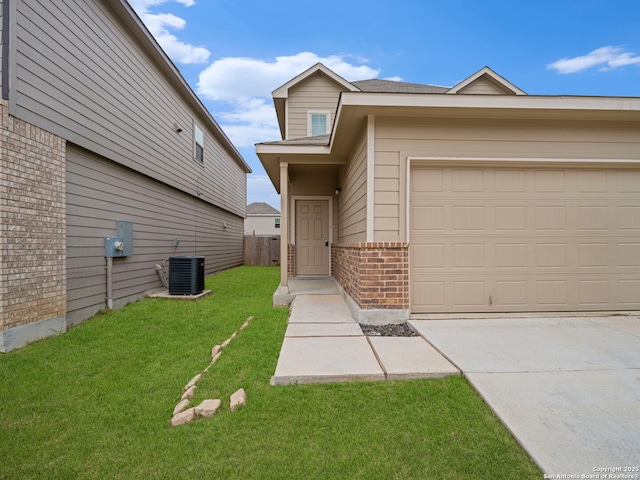 10518 Green Rock, San Antonio, TX 78223 - view of front facade with brick siding, central air condition unit, a front yard, an attached garage, and concrete driveway