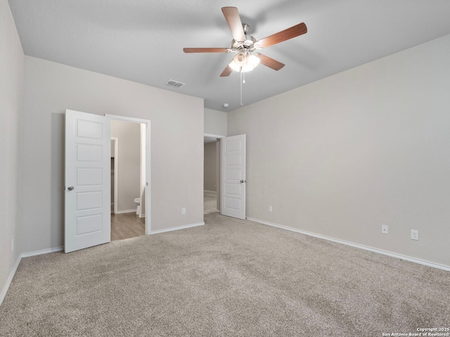 10518 Green Rock, San Antonio, TX 78223 - unfurnished bedroom with carpet, baseboards, ensuite bathroom, and a ceiling fan