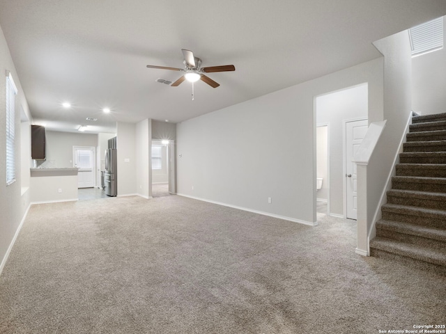 10518 Green Rock, San Antonio, TX 78223 - unfurnished living room featuring ceiling fan, stairway, light colored carpet, baseboards, and recessed lighting