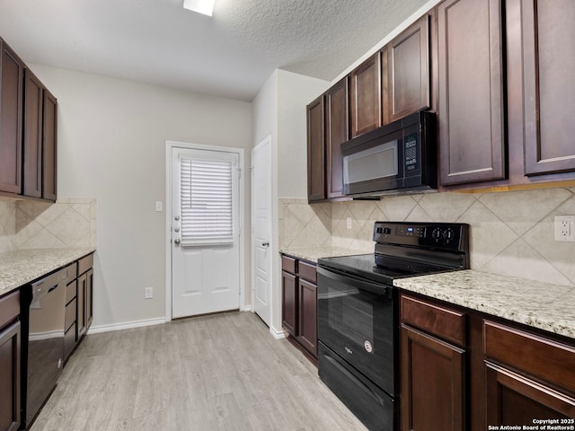 10518 Green Rock, San Antonio, TX 78223 - kitchen featuring black appliances, light wood-style floors, tasteful backsplash, light stone counters, and a textured ceiling