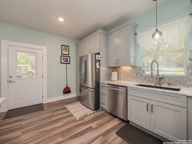 2872 Lakeview Dr, Canyon Lake, TX 78133 - kitchen featuring appliances with stainless steel finishes, a sink, light countertops, decorative backsplash, and recessed lighting