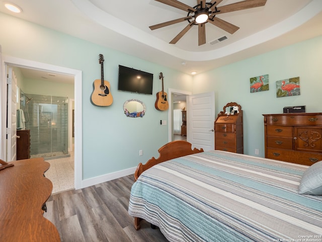 2872 Lakeview Dr, Canyon Lake, TX 78133 - bedroom featuring wood finished floors, baseboards, connected bathroom, a raised ceiling, and recessed lighting