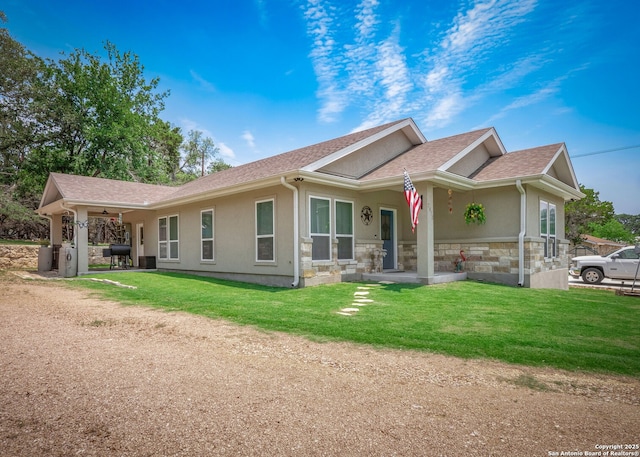 2872 Lakeview Dr, Canyon Lake, TX 78133 - view of home's exterior with stucco siding, stone siding, a lawn, a shingled roof, and ceiling fan