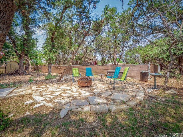 2872 Lakeview Dr, Canyon Lake, TX 78133 - fenced backyard featuring an outdoor fire pit and a patio area