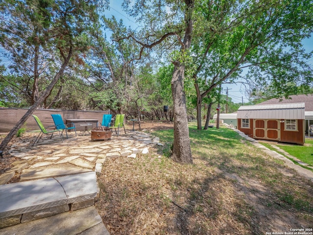 2872 Lakeview Dr, Canyon Lake, TX 78133 - view of green lawn with an outdoor fire pit and a patio