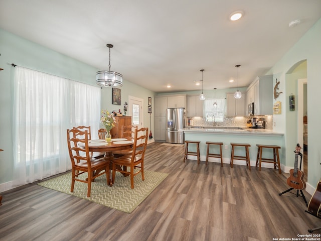 2872 Lakeview Dr, Canyon Lake, TX 78133 - dining space featuring dark wood-style floors, arched walkways, recessed lighting, and baseboards