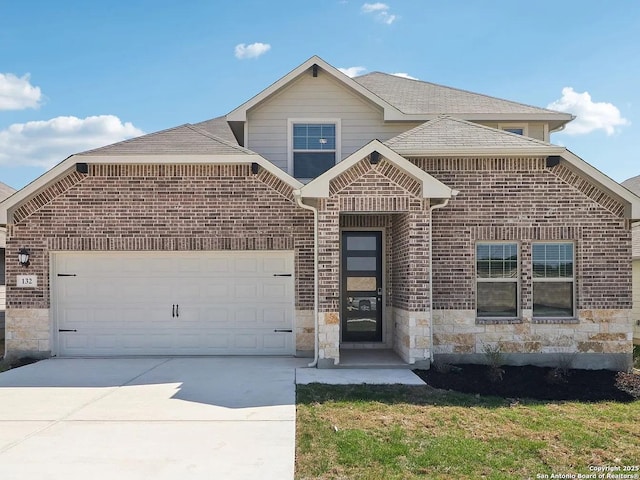 132 Shelton Pass, Cibolo, TX 78108 - view of front of property featuring brick siding, driveway, a garage, stone siding, and a shingled roof