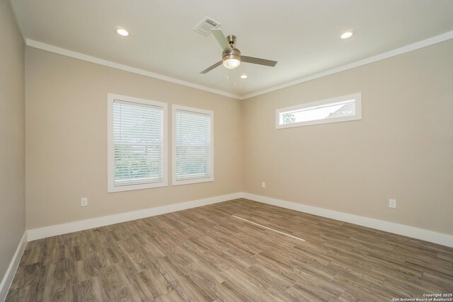 2115 W Houston, San Antonio, TX 78207 - empty room featuring ornamental molding, wood finished floors, ceiling fan, baseboards, and recessed lighting