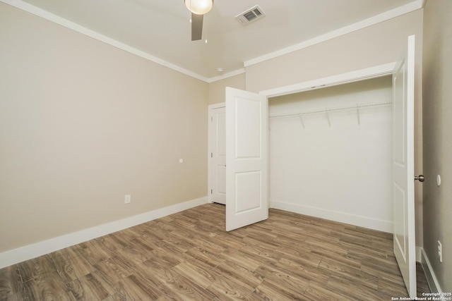 2115 W Houston, San Antonio, TX 78207 - unfurnished bedroom featuring ornamental molding, wood finished floors, a closet, baseboards, and a ceiling fan