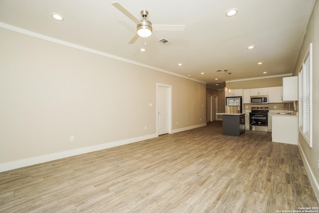 2115 W Houston, San Antonio, TX 78207 - unfurnished living room with crown molding, a sink, recessed lighting, a ceiling fan, and baseboards