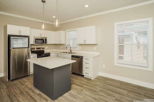 2115 W Houston, San Antonio, TX 78207 - kitchen with appliances with stainless steel finishes, a sink, crown molding, a kitchen island, and pendant lighting