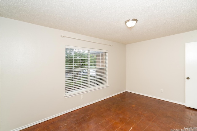 5731 Bypass Trl, San Antonio, TX 78244 - unfurnished room featuring a textured ceiling, tile patterned floors, and baseboards