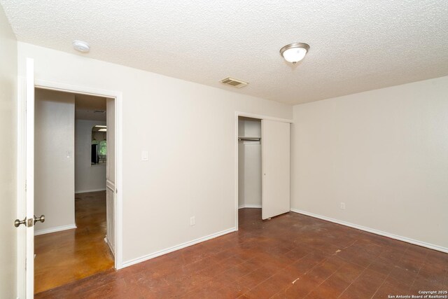 5731 Bypass Trl, San Antonio, TX 78244 - unfurnished bedroom featuring a closet, a textured ceiling, and baseboards