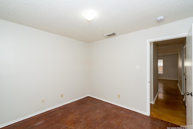 5731 Bypass Trl, San Antonio, TX 78244 - spare room featuring a smoke detector, baseboards, wood finished floors, and a textured ceiling