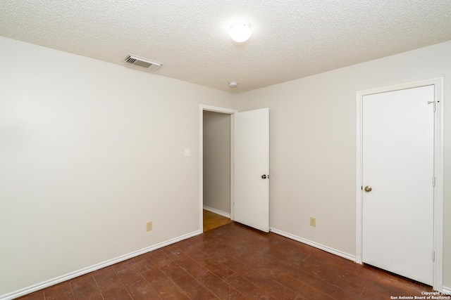 5731 Bypass Trl, San Antonio, TX 78244 - unfurnished bedroom with wood finished floors, a textured ceiling, and baseboards