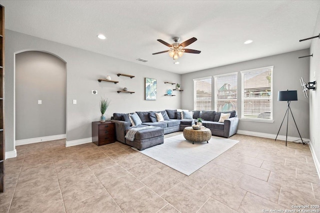 10218 Nate Range, San Antonio, TX 78254 - living area with arched walkways, a ceiling fan, recessed lighting, baseboards, and light tile patterned floors