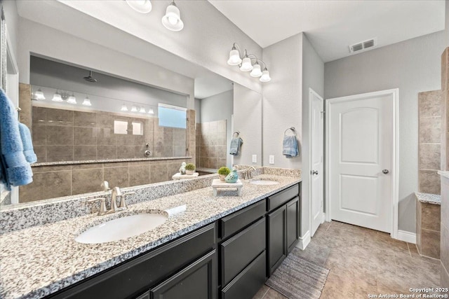 10218 Nate Range, San Antonio, TX 78254 - bathroom featuring double vanity and a walk in shower
