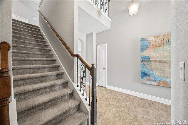 10218 Nate Range, San Antonio, TX 78254 - stairs with a towering ceiling, baseboards, and arched walkways
