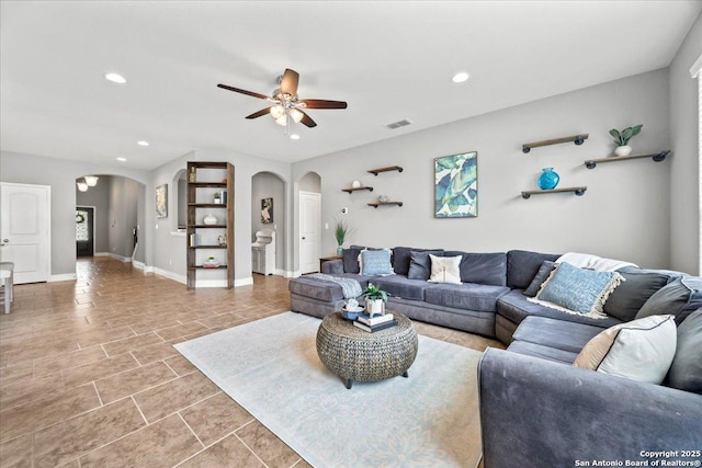 10218 Nate Range, San Antonio, TX 78254 - living room featuring arched walkways, ceiling fan, light tile patterned floors, recessed lighting, and baseboards