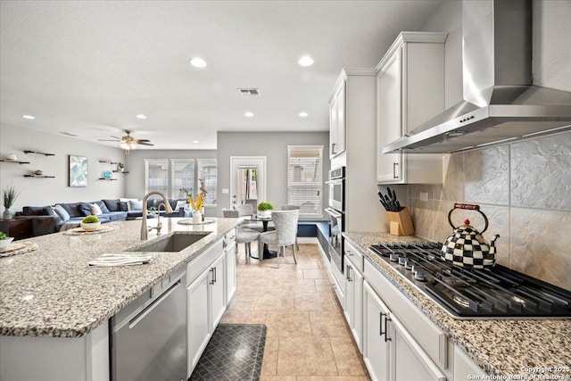 10218 Nate Range, San Antonio, TX 78254 - kitchen featuring wall chimney range hood, appliances with stainless steel finishes, a sink, healthy amount of natural light, and recessed lighting
