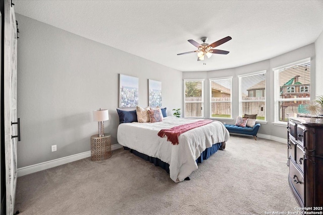 10218 Nate Range, San Antonio, TX 78254 - bedroom with light carpet, baseboards, and a ceiling fan