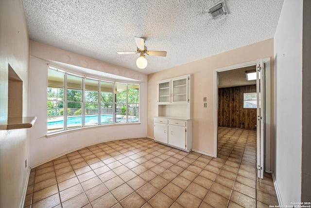 402 Waycrest, Windcrest, TX 78239 - empty room with ceiling fan, plenty of natural light, and a textured ceiling