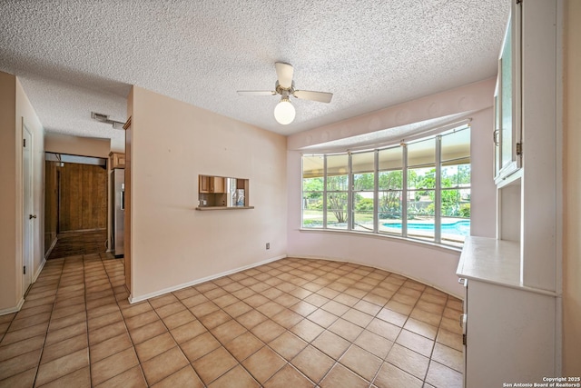402 Waycrest, Windcrest, TX 78239 - empty room with a ceiling fan, light tile patterned flooring, and a textured ceiling