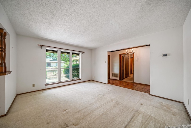 402 Waycrest, Windcrest, TX 78239 - carpeted spare room featuring a chandelier, a textured ceiling, and baseboards