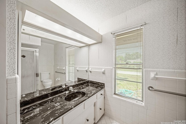 402 Waycrest, Windcrest, TX 78239 - bathroom featuring tile walls, toilet, vanity, a stall shower, and a textured ceiling