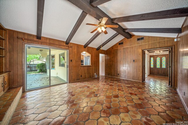 402 Waycrest, Windcrest, TX 78239 - unfurnished living room featuring wooden walls, ceiling fan, a chandelier, stone finish flooring, and a textured ceiling