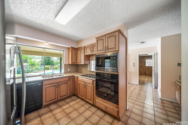 402 Waycrest, Windcrest, TX 78239 - kitchen featuring black appliances, a sink, a textured ceiling, light countertops, and light tile patterned floors