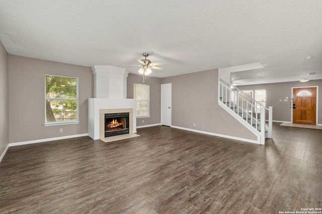 8131 Talkenhorn, Converse, TX 78109 - unfurnished living room featuring stairway, wood finished floors, a textured ceiling, ceiling fan, and baseboards