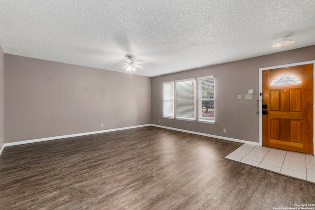 8131 Talkenhorn, Converse, TX 78109 - entryway with a ceiling fan, wood finished floors, a textured ceiling, and baseboards