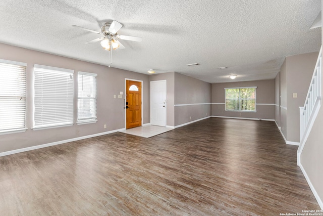 8131 Talkenhorn, Converse, TX 78109 - unfurnished living room with wood finished floors, ceiling fan, a textured ceiling, and baseboards