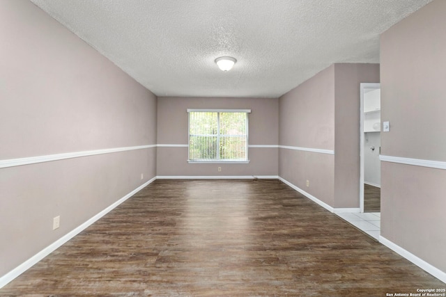 8131 Talkenhorn, Converse, TX 78109 - spare room featuring a textured ceiling, wood finished floors, and baseboards