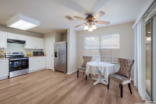 135 Agency Oaks, San Antonio, TX 78249 - kitchen with stainless steel appliances, light wood finished floors, white cabinets, and light countertops