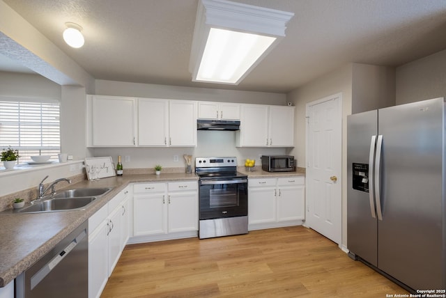 135 Agency Oaks, San Antonio, TX 78249 - kitchen featuring stainless steel appliances, a sink, under cabinet range hood, and white cabinetry