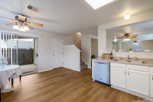 135 Agency Oaks, San Antonio, TX 78249 - kitchen featuring dishwasher, a ceiling fan, a sink, light wood-type flooring, and white cabinets